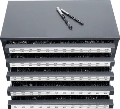 A gray metal organizer with multiple drawers filled with drill bits, with two drill bits on top.