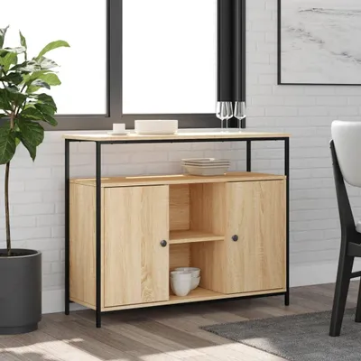 A sideboard with two doors and a shelf inside, placed in a room with a window and a plant.
