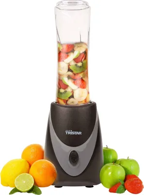 A Tristar smoothie maker with a glass jar filled with fruit, surrounded by fresh fruits like oranges, lemons, limes, and apples.