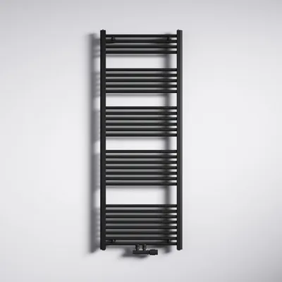 A black radiator is mounted on a white wall.