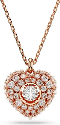 A close-up studio shot of a rose gold heart-shaped pendant necklace with diamonds.