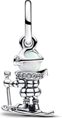 A silver charm of a skier with an opal.