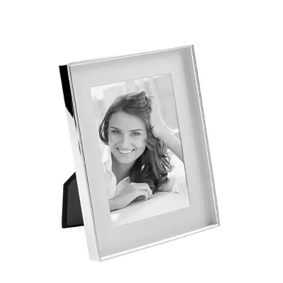 A silver-colored picture frame with a black stand, displaying a black and white photo of a woman.