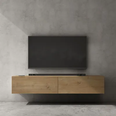 A modern, wall-mounted TV stand with a dark screen television and a soundbar, against a concrete wall.