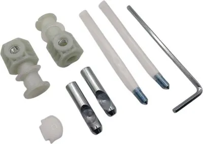 A collection of plumbing hardware parts, including plastic mounting brackets, metal punch tools, and an Allen wrench, arranged on a white background.