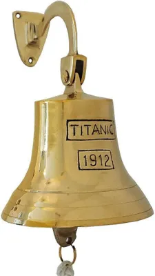 A brass bell with "TITANIC 1912" inscribed on it, mounted on a wall bracket.
