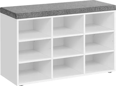 A white shoe bench with a gray upholstered top and nine open compartments.