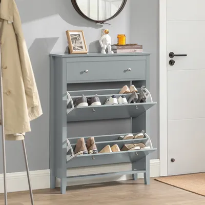 A gray shoe cabinet with two flip-down drawers and a single drawer on top, placed in a hallway next to a door and a coat rack.