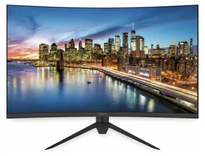 A curved computer monitor displaying a cityscape at dusk.
