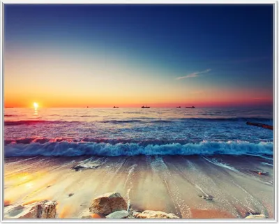 Produktbild von Wallario Wandbild Sonnenuntergang am Meer mit Wellen am Strand, Größe: 40,30 x 50,30 cm, Poster mit weißem Aluminiumrahmen