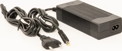 A black power adapter with cables and plugs on a white background.