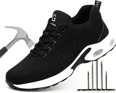 A black safety shoe with a white sole, shown with a hammer and nails to demonstrate its protective features.