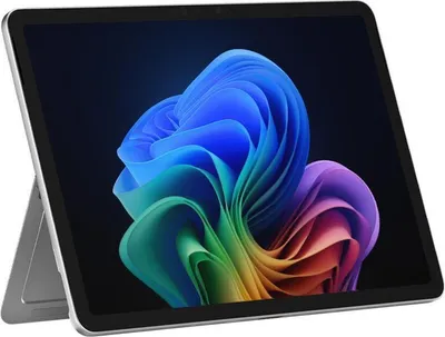 A Microsoft Surface Pro tablet is shown from a slightly angled front view, displaying a colorful abstract wallpaper on its screen. The tablet is propped up by its integrated kickstand.