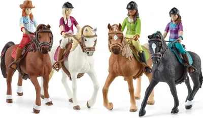Four toy horses with riders, posed in a line against a white background.