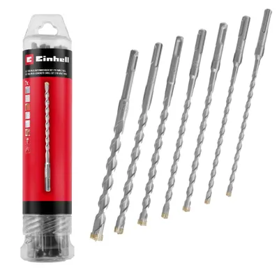 A set of SDS-Plus drill bits in a clear plastic tube packaging, with the drill bits arranged diagonally next to the packaging.