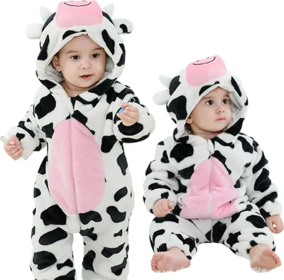 Two babies wearing cow costumes.