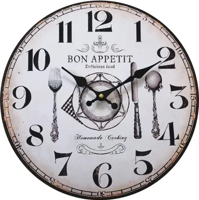 A round wall clock with a vintage design, featuring kitchen-themed illustrations and text.