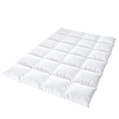 A white quilted comforter or duvet laid out flat on a white background.