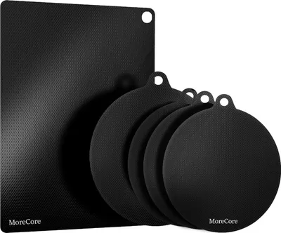 A set of black induction hob protectors, one rectangular and four circular, are arranged on a white background.