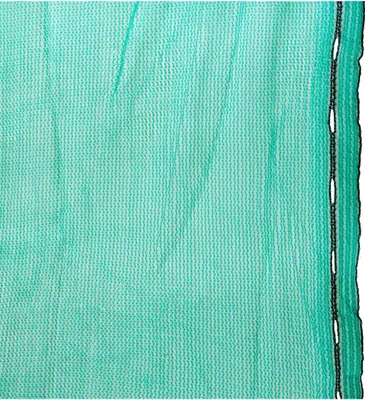 A close-up of a green mesh fabric with a black edge and grommets.