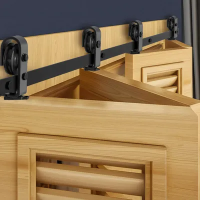 A close-up view of a sliding door track system mounted above wooden doors.