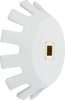 A white plastic part with a gold-colored insert in the center, against a white background.