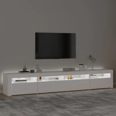 A modern white TV stand with LED lighting, featuring a large flat-screen TV mounted on the wall above it.