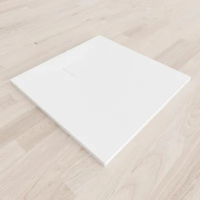 A white shower tray is placed on a light wooden floor.