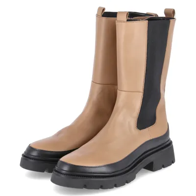 A pair of beige and black women's boots on a white background.