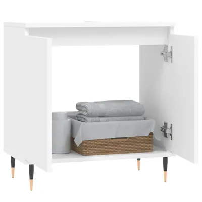 A white bathroom cabinet with two doors open, revealing towels and a basket inside.