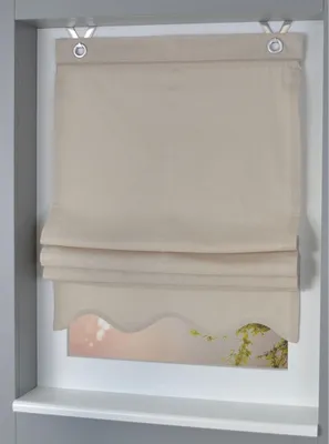 A beige Roman blind is installed in a window frame.