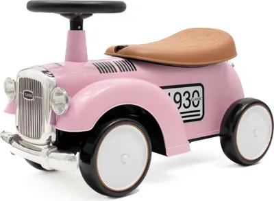 A pink ride-on toy car with a brown seat and black steering wheel, set against a white background.