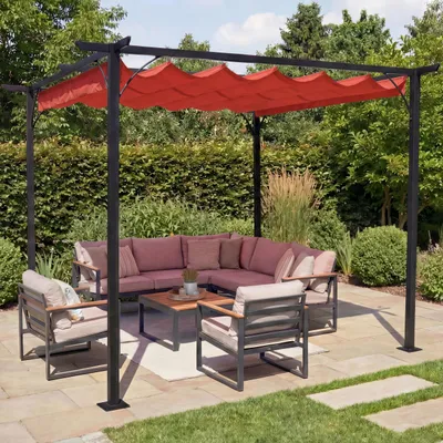 An outdoor patio with a pergola and seating area.