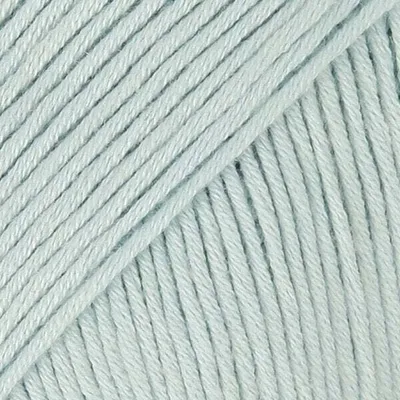 A close-up, textured view of mint-colored yarn.