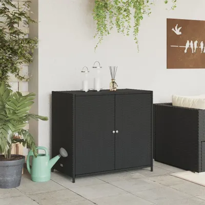 An outdoor cabinet on a patio with plants and a watering can.
