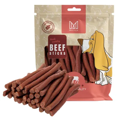 A bag of dog treats with some treats spilled in front.