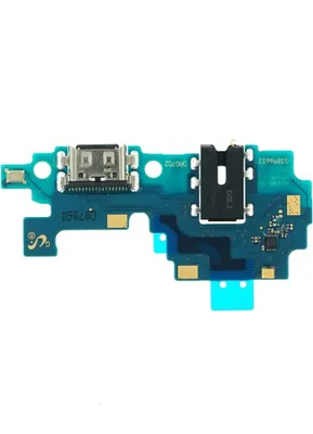 A close-up, top-down view of a smartphone charging port and headphone jack assembly on a circuit board, isolated on a white background.