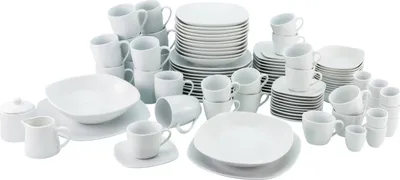 A collection of white porcelain dinnerware, including plates, bowls, and cups, arranged on a white background.