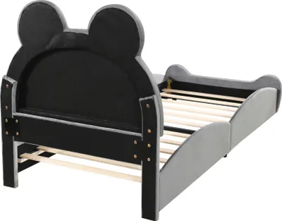 A children's bed with a bear-shaped headboard.