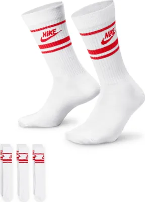 A pair of white Nike crew socks with red stripes and logos are shown, along with three more socks neatly arranged below.