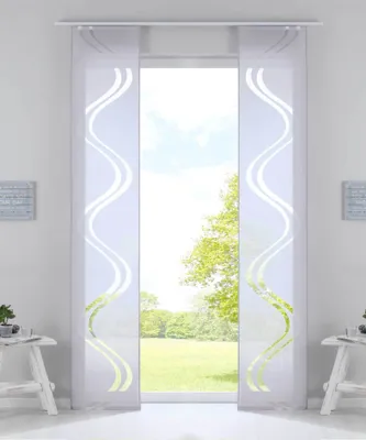 A window with two white panel curtains with a modern wave pattern, overlooking a green garden and trees.