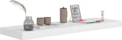 A white shelf with decorative items.