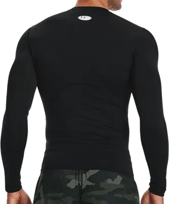 A person wearing a black long-sleeved shirt and camouflage shorts, viewed from the back.