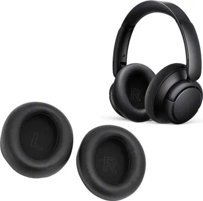 A pair of black headphones and two replacement ear pads are displayed on a white background.