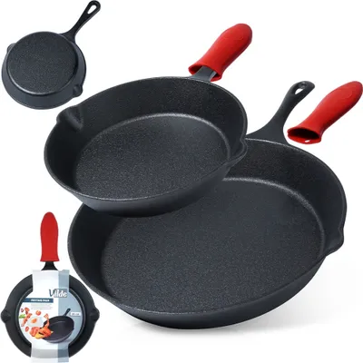 Two cast iron pans with red silicone handle covers, one smaller pan is placed on top of a larger pan. A smaller pan with a label is in the bottom left corner.