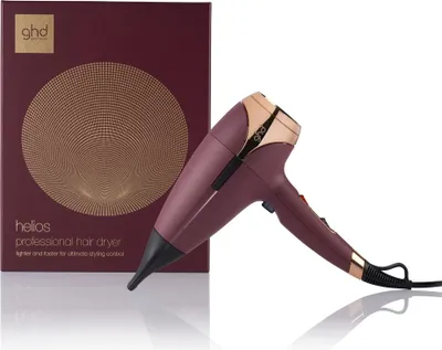 A burgundy GHD Helios professional hair dryer is shown next to its packaging.