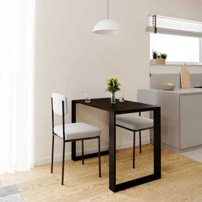 A small dining table with two chairs in a modern kitchen setting.