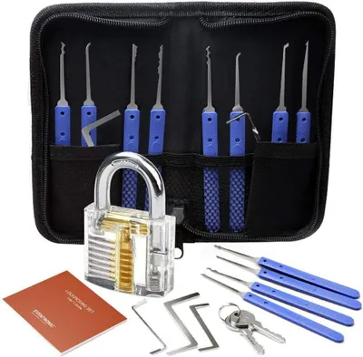 A lock picking set is laid out with a transparent practice lock, keys, and various lock picking tools.