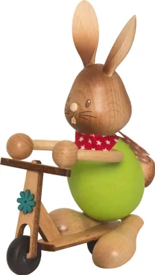 A wooden figurine of a rabbit riding a scooter.