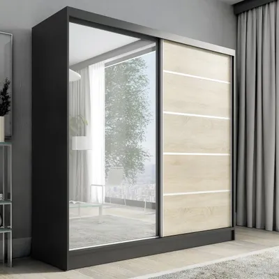 A modern sliding door wardrobe with a mirrored door and wood-effect panels, set against a neutral background with curtains.